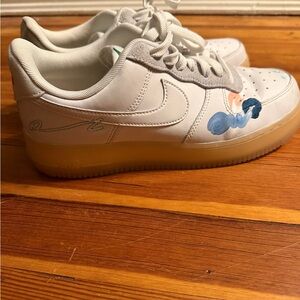 Nike White Sneakers with Artistic Blue and Pink Accents